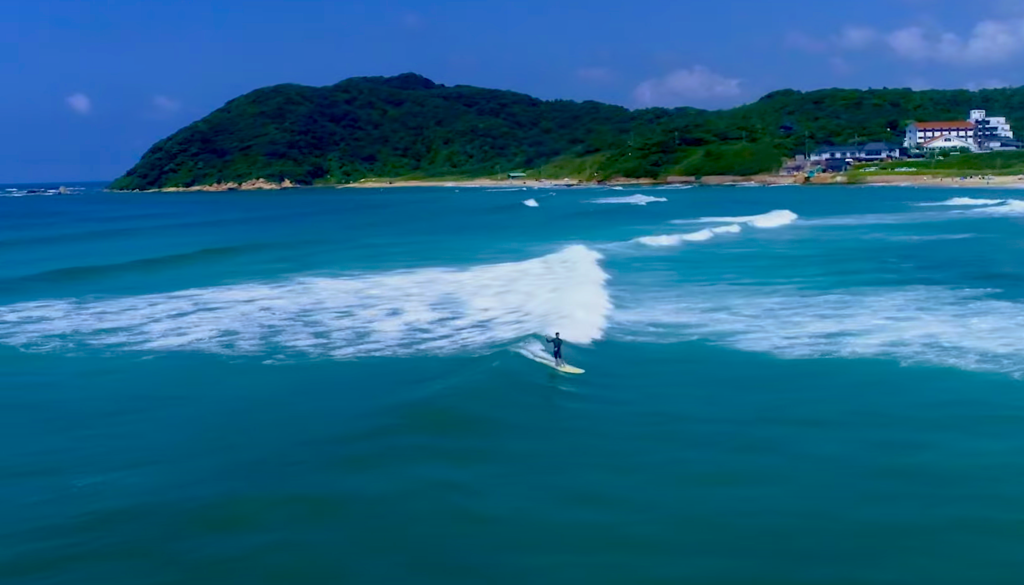 Longboarder trimming on gentle face