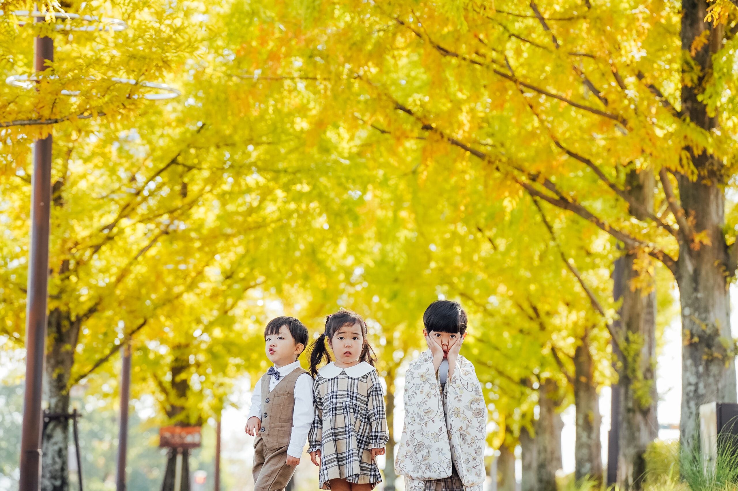 Arashiyama riverside path with layered autumn colors, wide scene