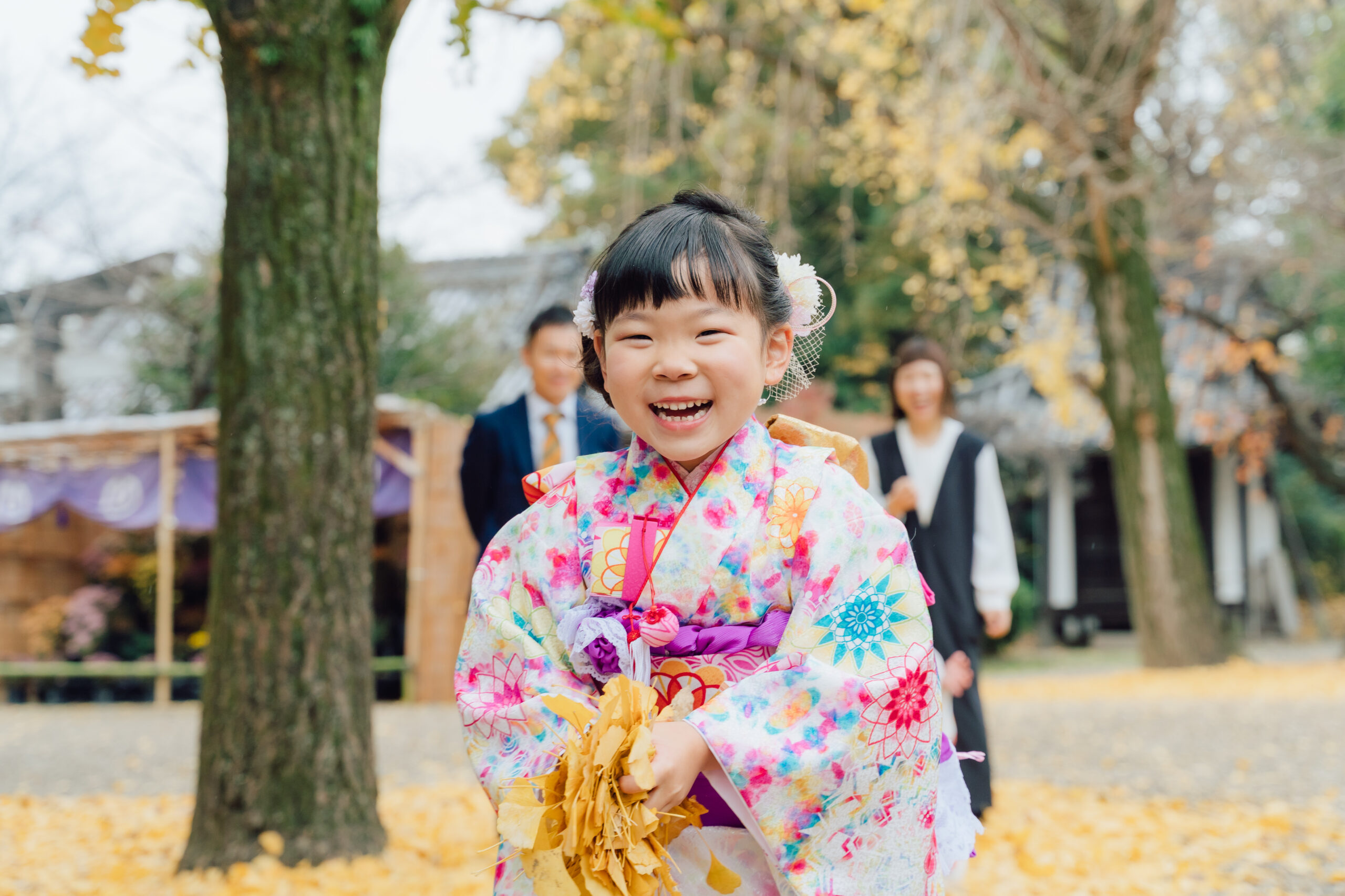 Kimono couple along shrine path, soft afternoon light