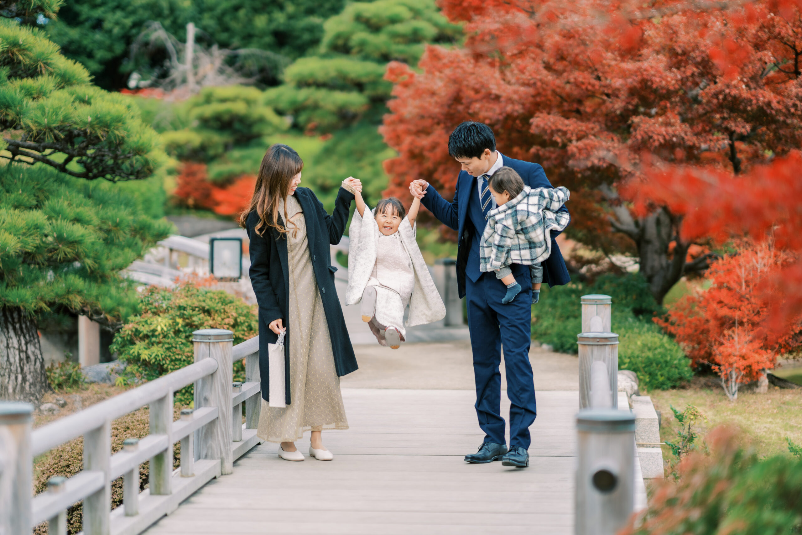 Family under maple canopy — gentle light