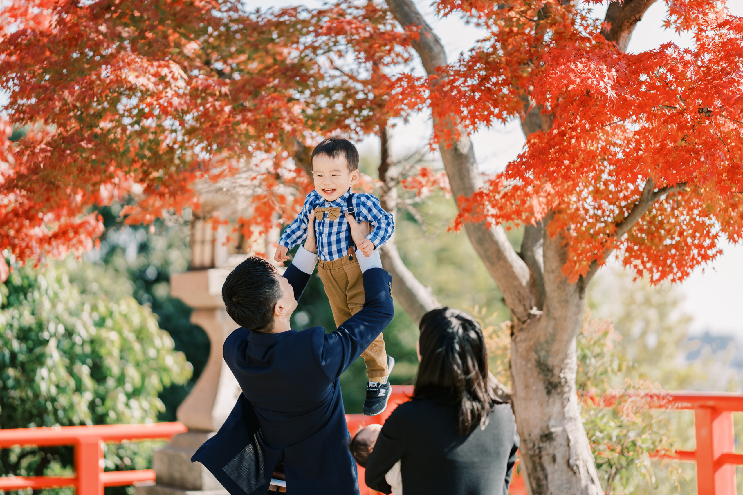 Red and amber leaves softly framing a portrait, shallow depth