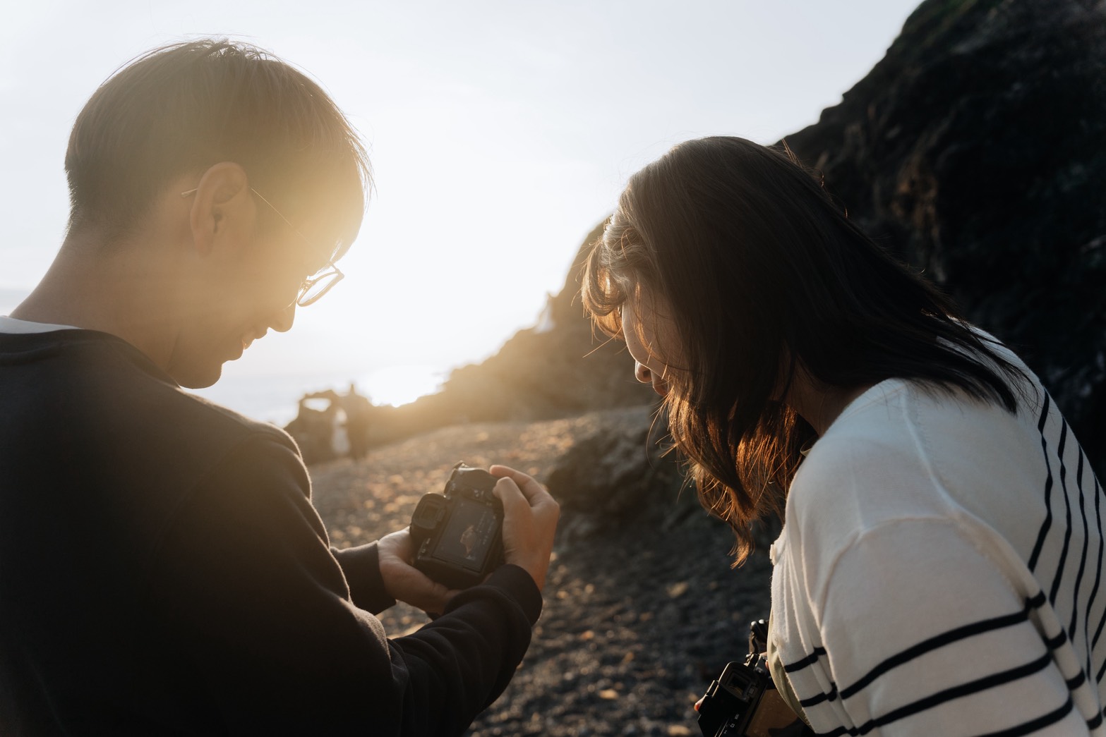 Sukemaru smiling in soft indoor light, approachable bilingual photographer